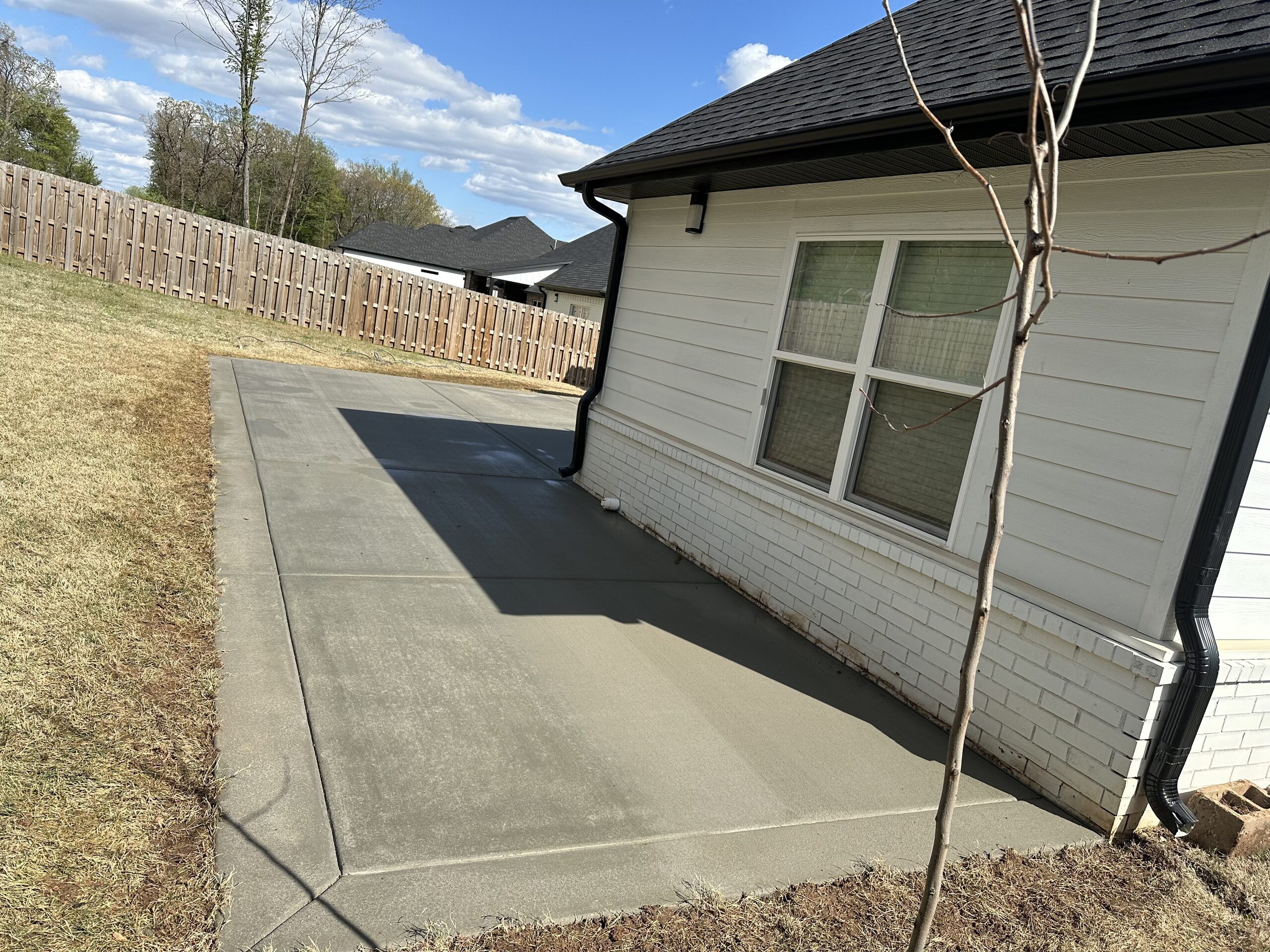 New concrete patio slab beside a home